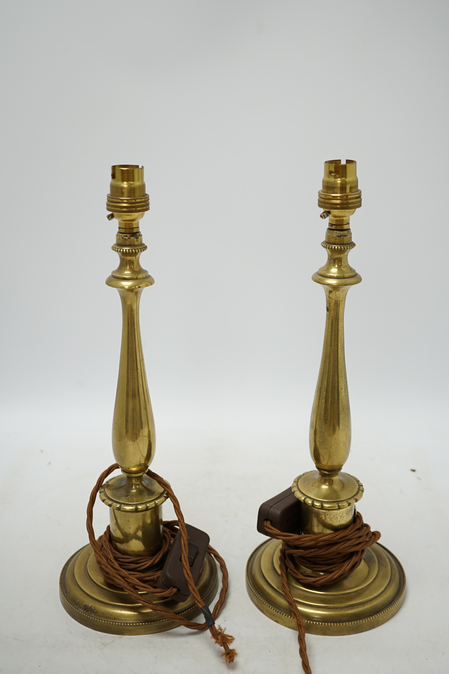 A pair of early 20th century brass table lamps, 36cm total height. Condition - fair, not tested